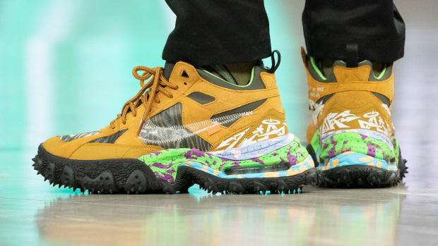 View of tan and black Nike shoes.